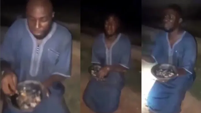 Mixed reactions as vigilante caught yahoo boy at midnight, forces him to eat the sacrifice (video)